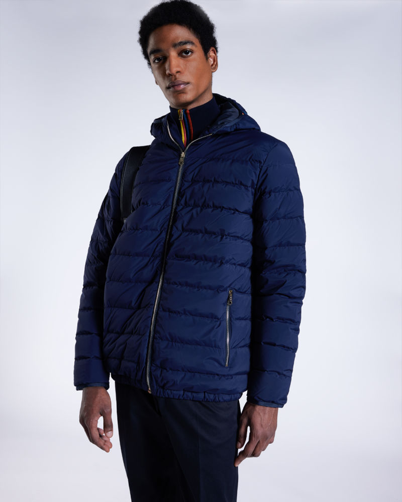 a male model wearing a designer zipped up navy puffer jacket